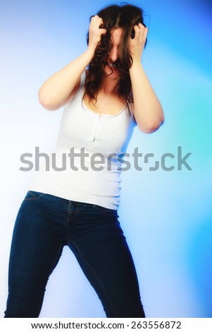 Stress negative emotions frustration. Young emotional woman angry frustrated and stressed pulling her hair. Studio shot