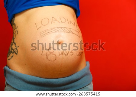 Closeup pregnant woman belly with loading concept painted on her tummy, creativity in the stage of uterine development, awaited new baby
