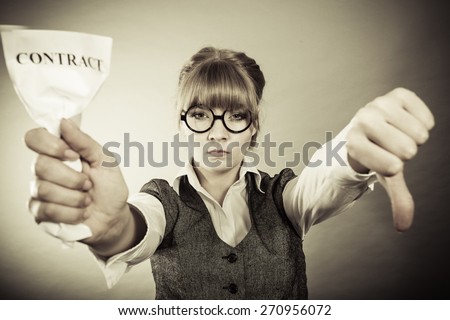 Business, documents and crisis concept - serious unhappy businesswoman showing crumpled contract making thumb down hand sign
