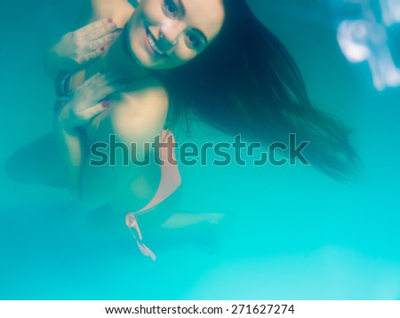 Leisure, relax and active lifestyle concept. Underwater girl wearing bikini swimming and diving