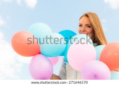 Summer holidays, celebration and lifestyle concept - Closeup beautiful woman teen girl with colorful balloons outside blue sky background