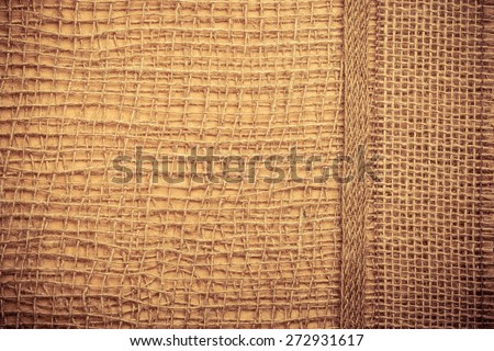 Jute bagging ribbon on brown mesh material, natural burlap ecology background