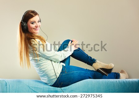 People leisure relax concept. Lovely woman big headphones listening music mp3 relaxing on couch