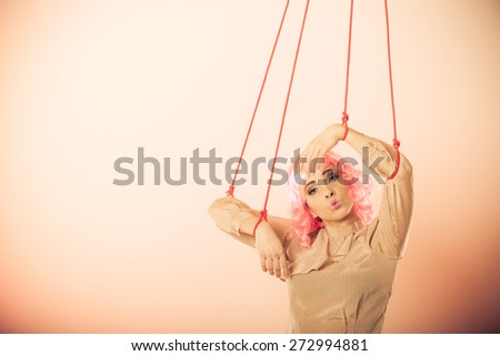 Young woman girl stylized like marionette puppet on string