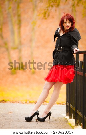 Fall lifestyle concept. fashion elegant young woman outdoor relaxing walking in autumn park