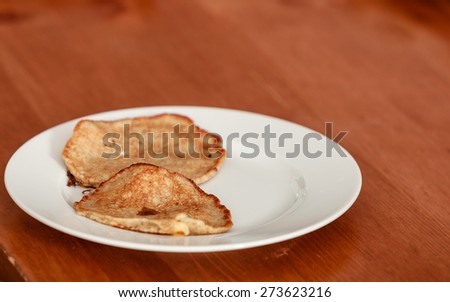 Fried apple in pancake dough or apple fritters pancakes with icing sugar