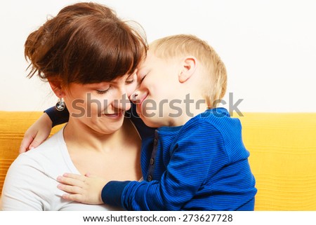 Happy family. Smiling blond son boy kid child hugging his mother expressing tender feelings. Love.