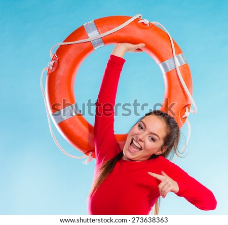 Accident prevention and water rescue. Young woman female smiling lifeguard on duty holding lifesaver equipment having fun on blue