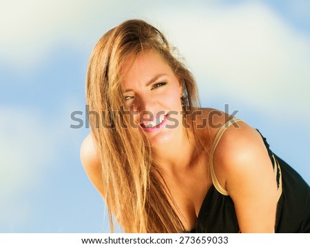 Happy smiling woman outdoor. Vacation day leisure concept. Positive young person outside on beach.