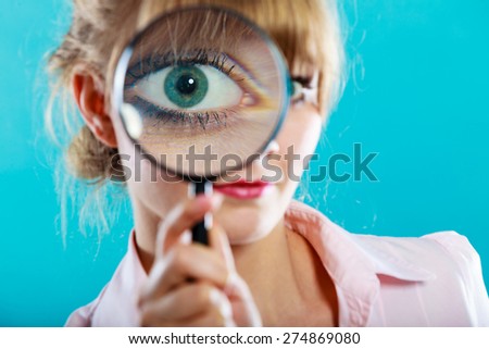 Investigation exploration education concept. Closeup funny woman face, girl holding on eye magnifying glass loupe
