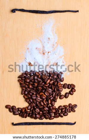 Cappuccino time. Roasted coffee beans placed in shape of cup with white froth vanilla pods on wooden surface background