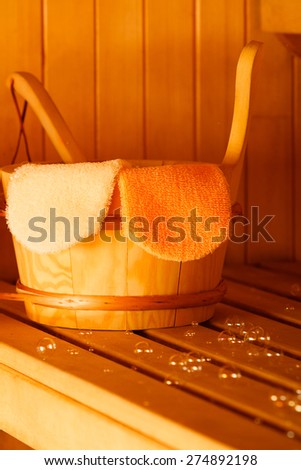 Beauty health spa and lifestyle concept. Interior of finnish sauna and accessories detail bucket ladle and exfoliation glove