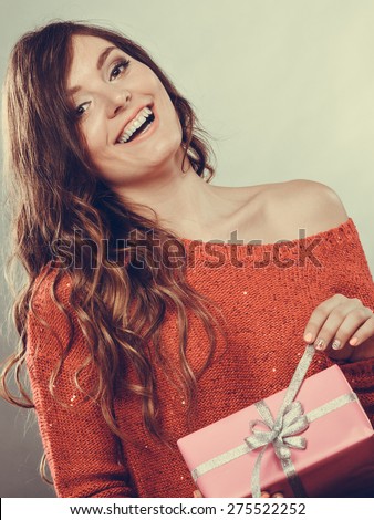 People celebrating xmas love and happiness concept - beauty girl opening present pink gift box, smiling positive face expression