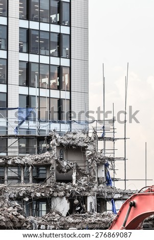 Urban scene. Dismantling of a house. Ruins of building under destruction in city center.  Industry.