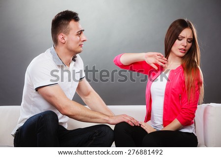 Young couple arguing argue on couch at home. Conflict between man and woman. End of relationship divorce after betrayal unfaithfulness.