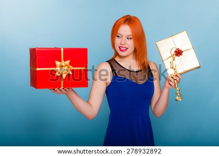 People celebrating holidays, love and happiness concept - happy red hair girl with gift boxes studio shot on blue background