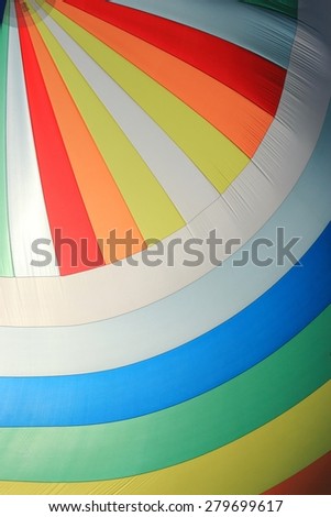 The wind has filled the spinnaker on sailing yacht. Detail of a colorful sail as background.