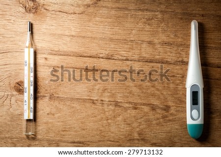 Medical background. Frame of mercury and electronic thermometer on wooden background. Fever.