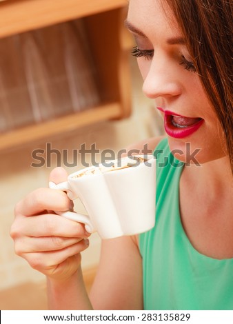 Woman drinking cup of coffee. Young girl with hot energizing beverage that keeps her awake. Energy and caffeine.