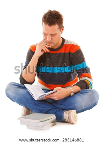 Man college student sitting and reading book studying for exam isolated. Studio shot.