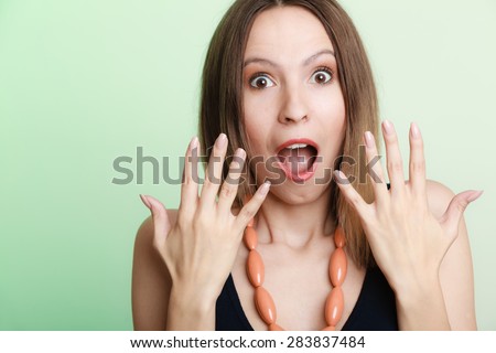 Emotional facial expression wide eyed woman surprised girl open mouth hand gesture.