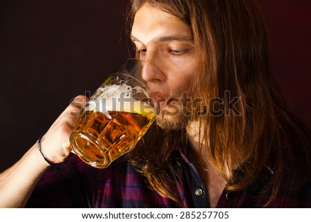 handsome young man guy drinking a glass of beer