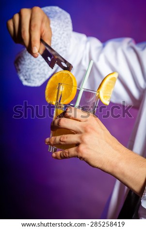 Young stylish man bartender preparing serving alcohol cocktail drink