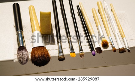 Beauty and makeup. Set of wet make-up brushes after washing drying on window sill