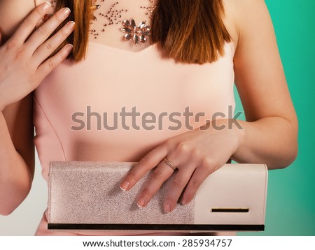 Female elegance. girl young woman holding in hand elegant handbag bag luxury accessory on green