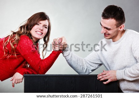Partnership relationship concept. Girlfriend confronts his boyfriend. Woman and man arm wrestling challenge between young couple