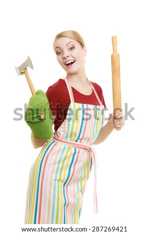 Happy housewife or baker chef wearing kitchen apron holds baking rolling pin meat hammer utensil isolated on white