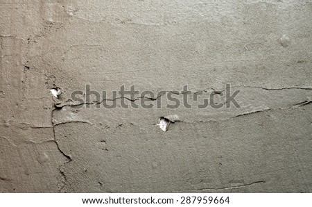 Construction worker is tiling at home, tile floor adhesive Abstract plaster stucco wall