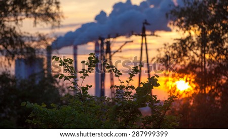 Energy. Smoke from chimney of power plant or station at the sunset. Industrial landscape.
