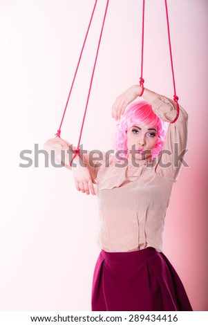 Young woman girl stylized like marionette puppet on string