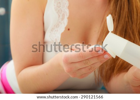Make up remove skin care. Closeup woman holding cotton swab and makeup remover in hands.