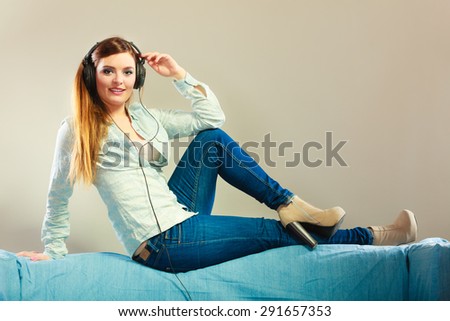 People leisure relax concept. Lovely woman big headphones listening music mp3 relaxing on couch