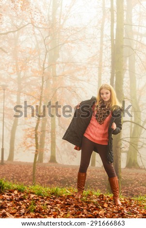 Woman walking relaxing in foggy day in romantic autumn forest park outdoor