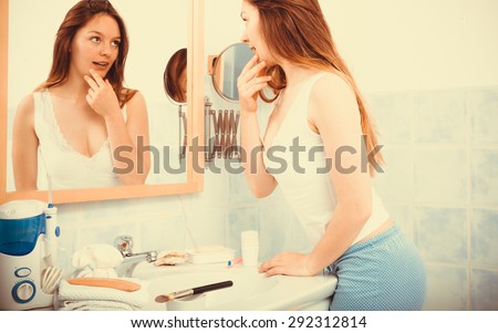 Young girl woman without makeup in bathroom looking in mirror. Natural beauty. Purity. Instagram filtered.