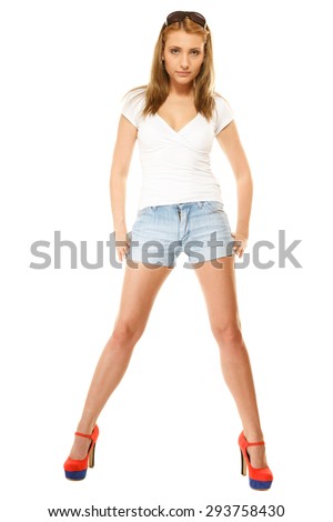 Summer fashion. Full length pretty young woman sensual girl in denim shorts, high heels isolated on white