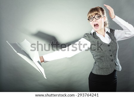 Fly fear metaphor, aerophobia concept. Business woman holding airplane in hand.
