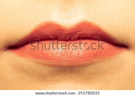Cosmetic beauty procedures and makeover concept. Closeup part of woman face red lips makeup detail. Lipstick or lipgloss