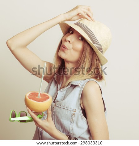 Woman tourist in straw hat drinking grapefruit juice and holding sunglasses. Healthy diet food. Weight loss. Summer vacation holidays.