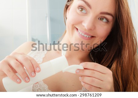 Woman removing makeup with cotton swab pad. Young girl taking care of skin. Skincare concept.