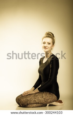 Graceful beautiful woman ballet dancer full length studio shot sepia vintage aged tone