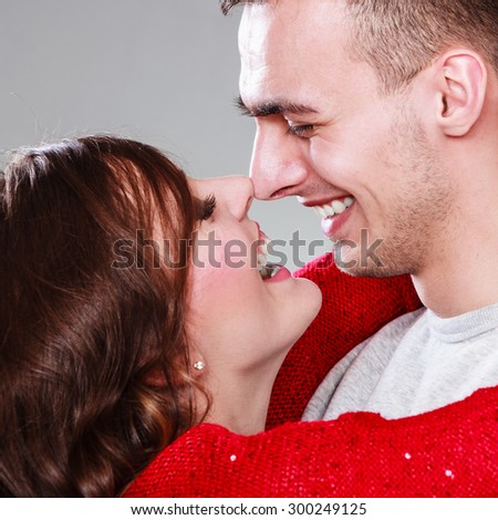 Portrait of young couple woman man face to face gray background