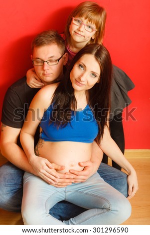 Pregnancy, parenthood and happiness concept. Family expecting new baby, portrait of three face at home