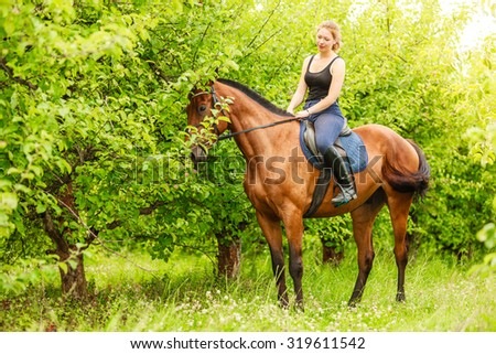 Active woman girl jockey training riding horse. Sport activity.