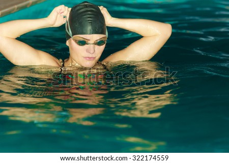 Woman athlete in swimming pool water. Water sport comptetition exercise. Human swimmer training.