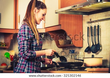 Woman in kitchen cooking stir fry frozen vegetables. Dinner food meal. Instagram filter.
