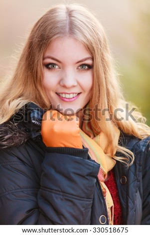Pretty woman in fall forest park. Gorgeous girl in jacket. Autumn winter fashion.
